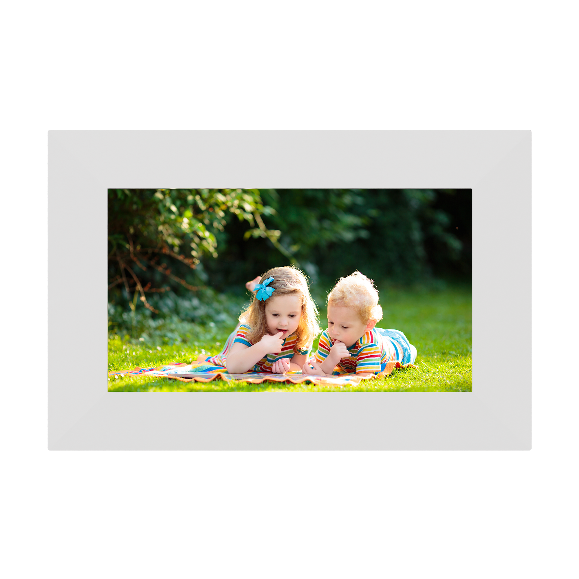 Digital photo frame displaying two children on a grassy field