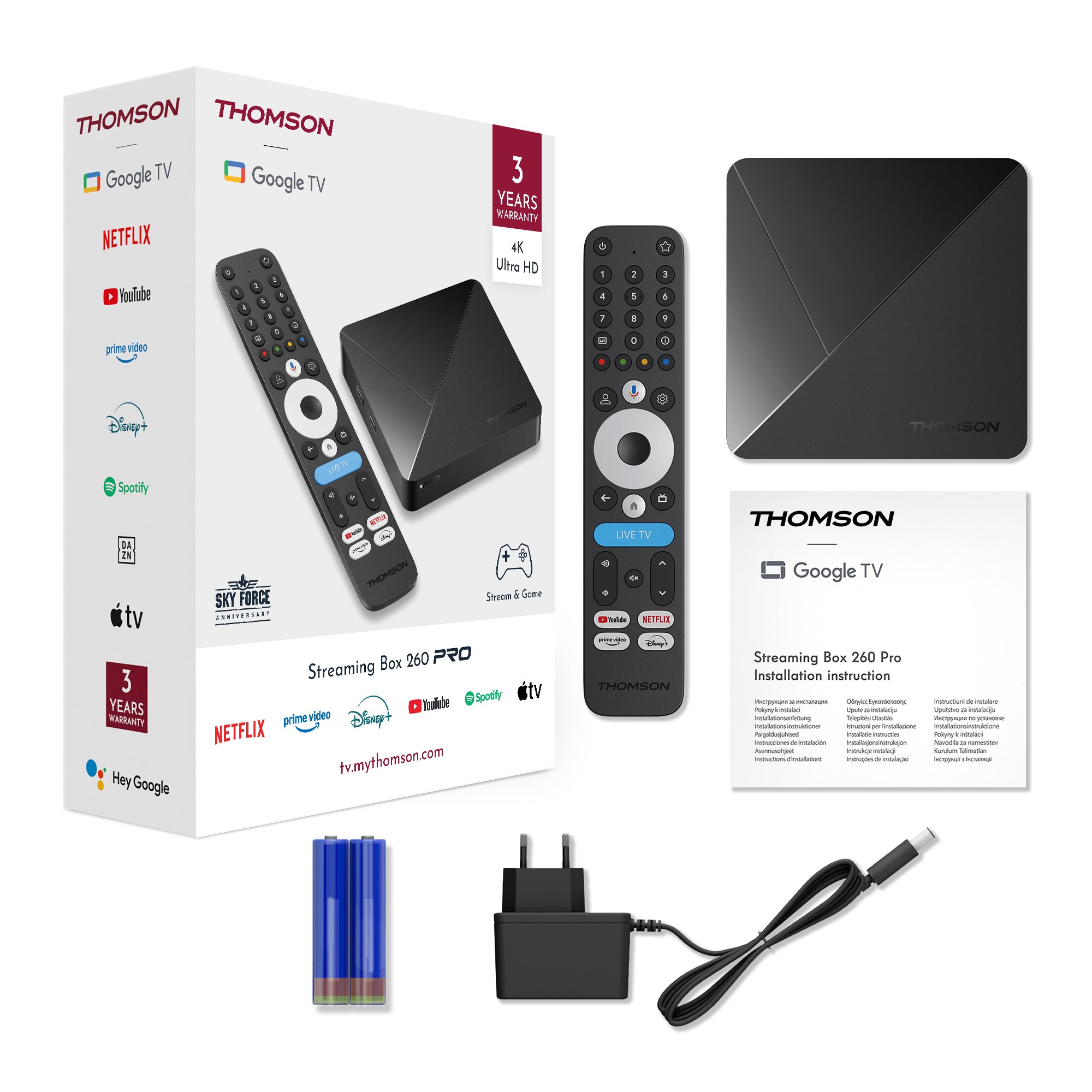 Thomson Google TV streaming box with remote, power adapter, and installation manual on a white background