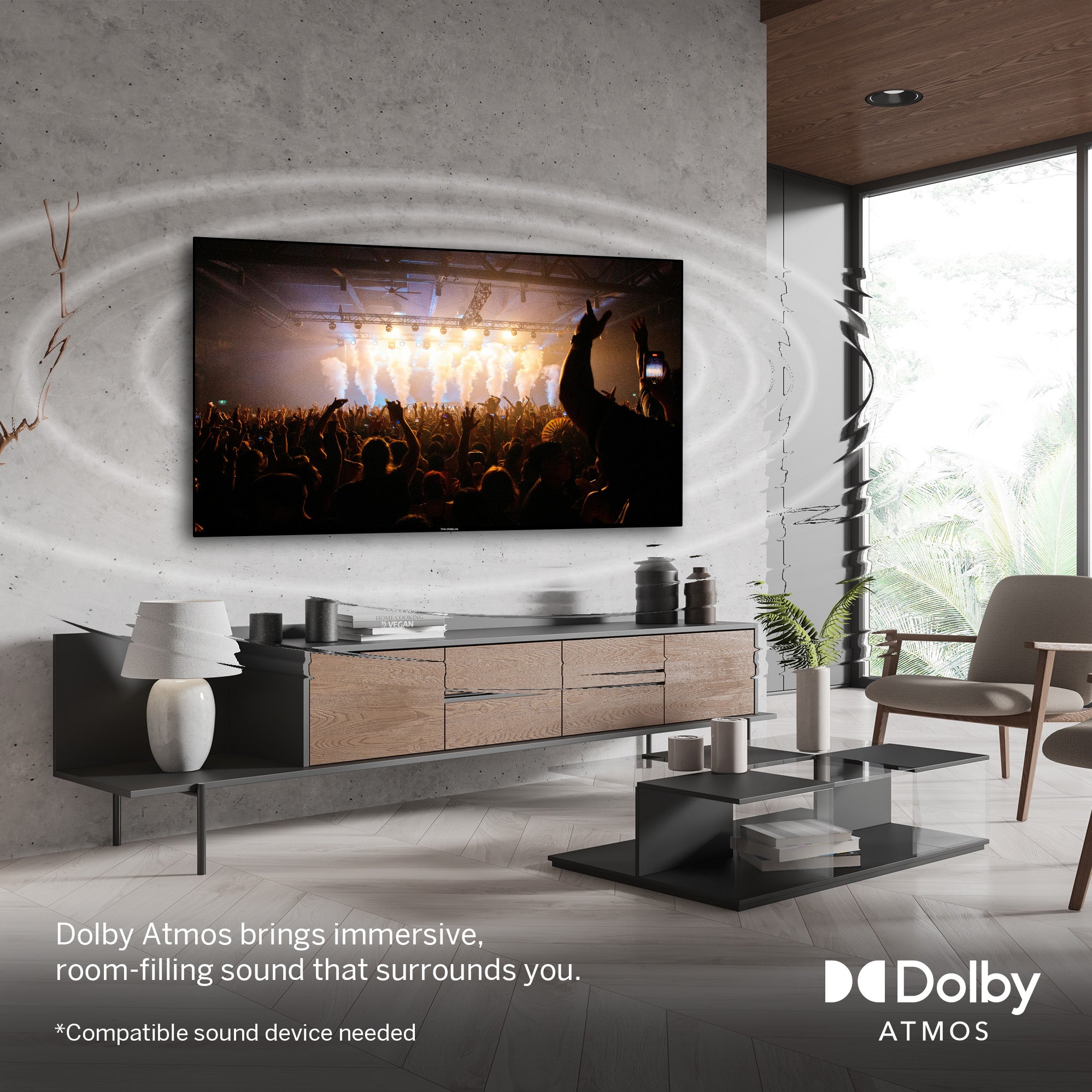 Modern living room with a large TV displaying a concert scene, Dolby Atmos branding visible.