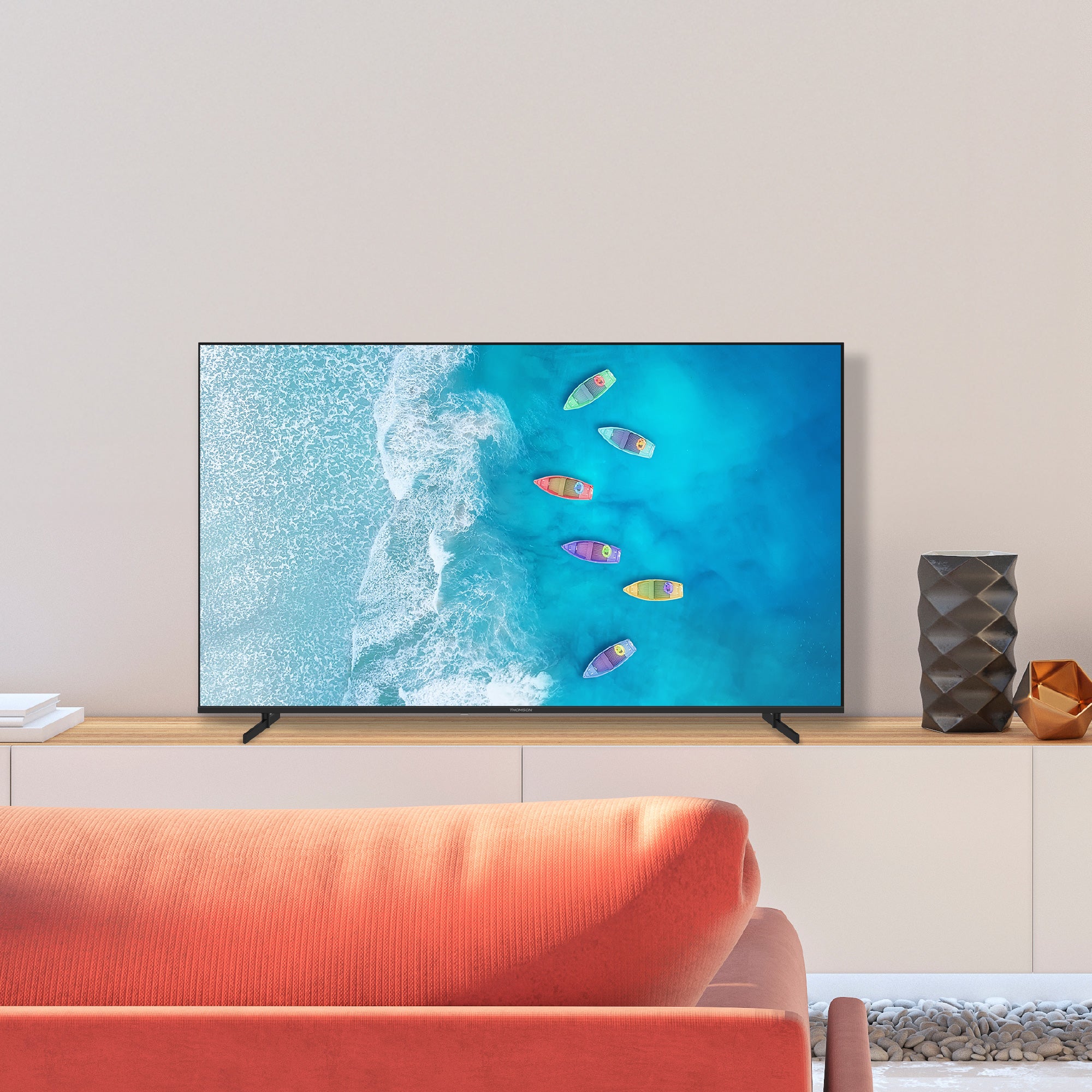 Smart TV displaying an ocean scene with boats in a modern living room.