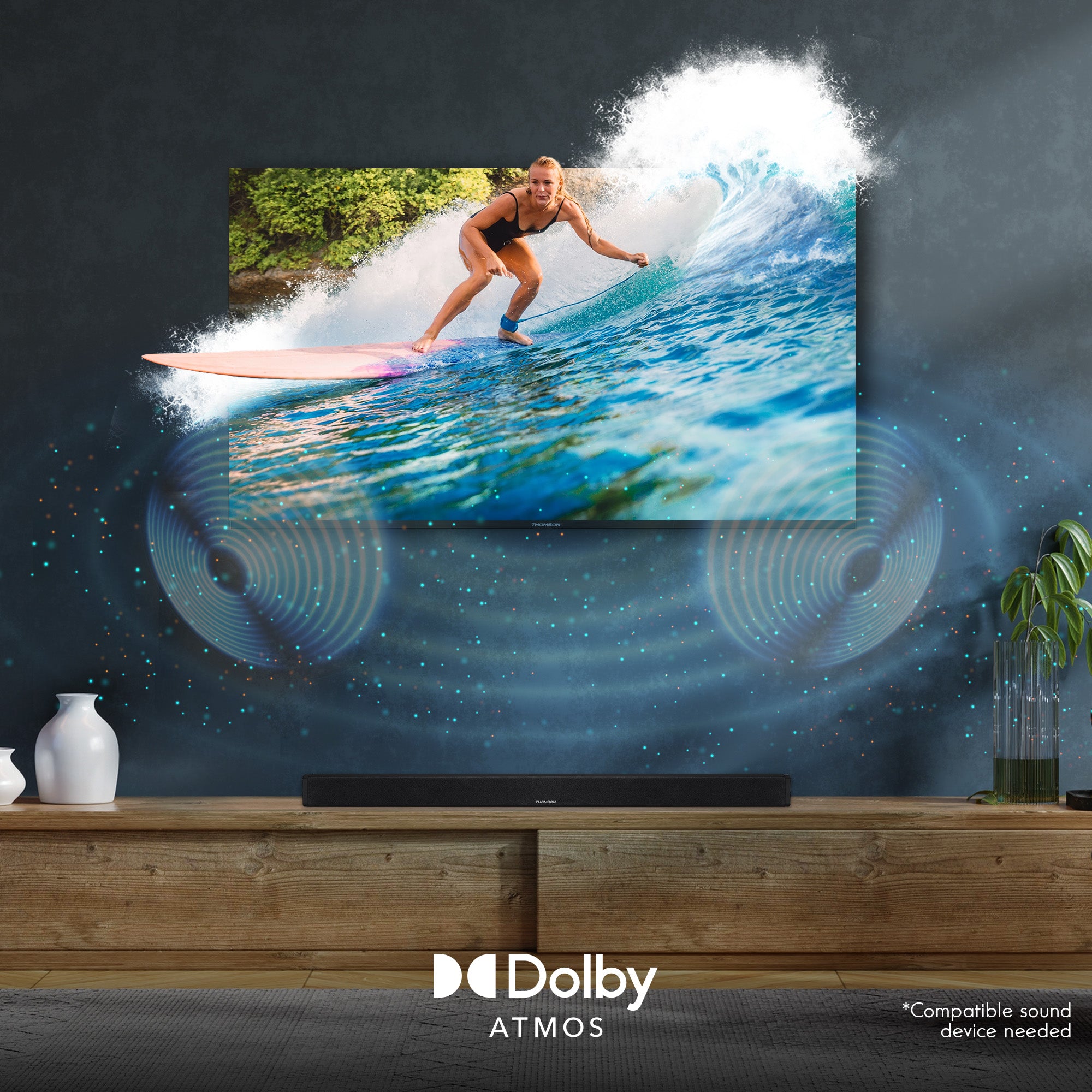 TV screen displaying a surfer on a wave with Dolby Atmos branding in a room.
