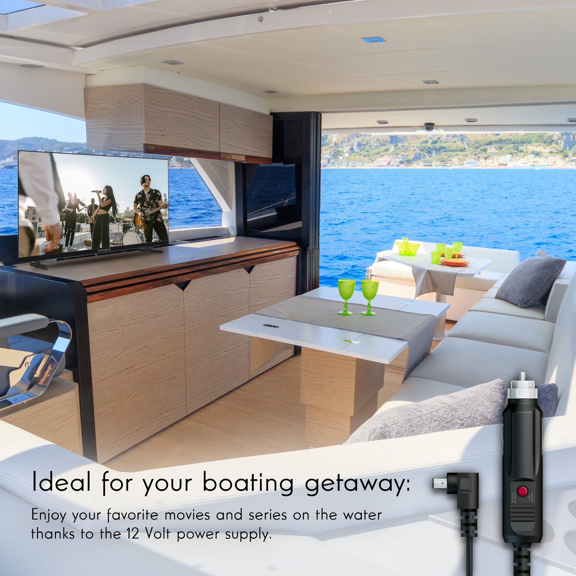 Interior of a boat with a television and power supply cable, overlooking water.