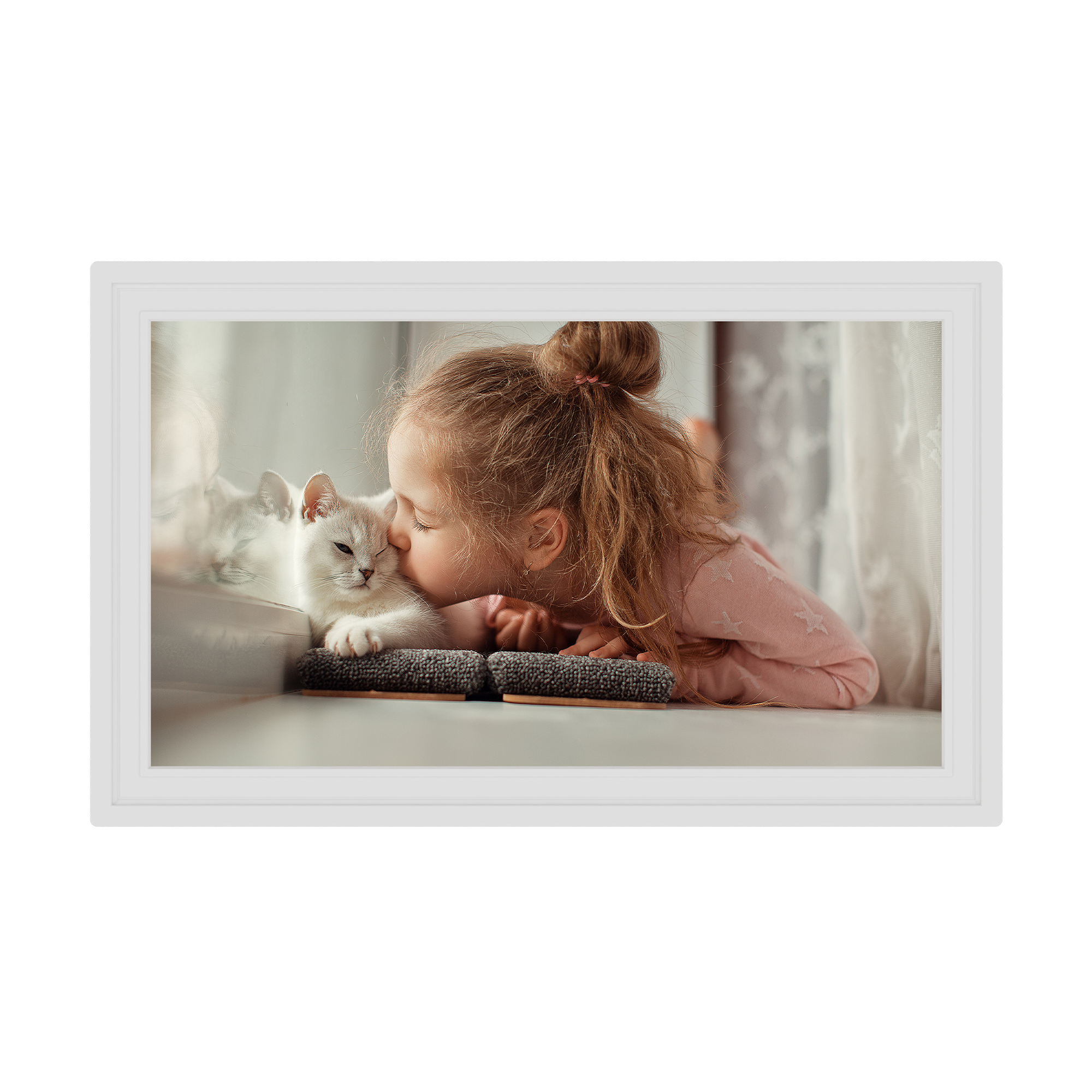 Framed picture of a child and a cat lying on a bed