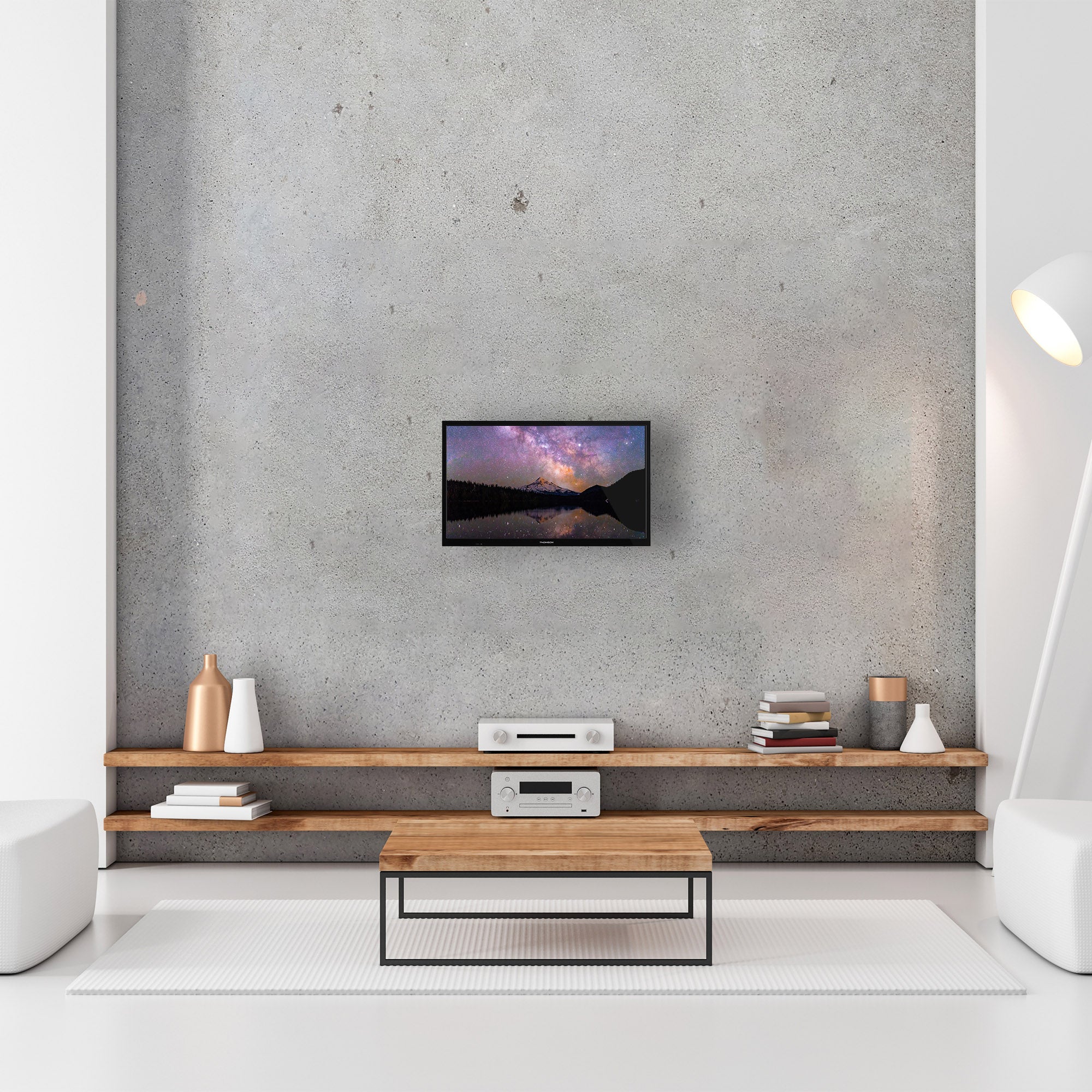 Modern living room with a flat-screen TV mounted on a concrete wall.