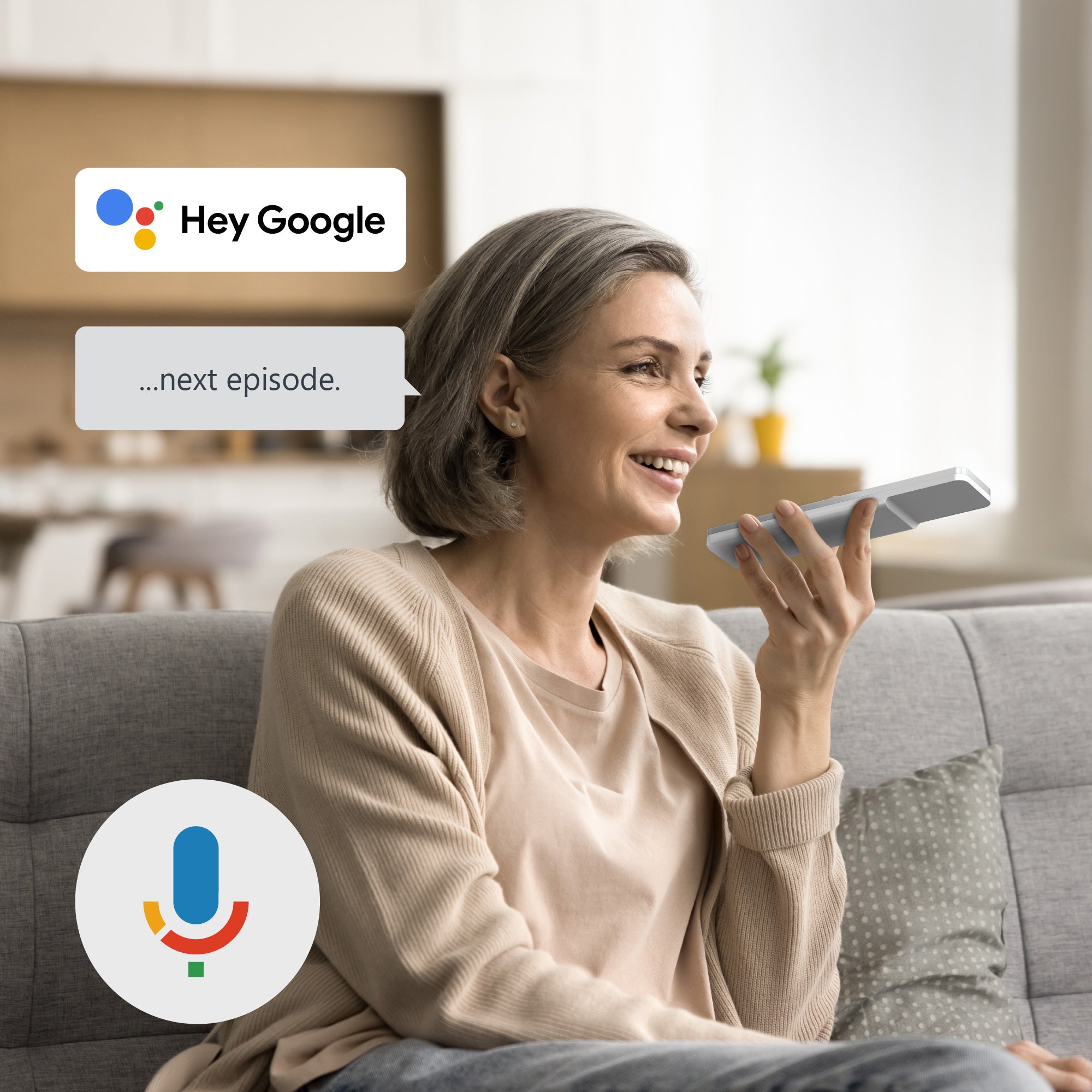 Woman sitting on a couch using a smartphone with 'Hey Google' displayed, in a living room setting.