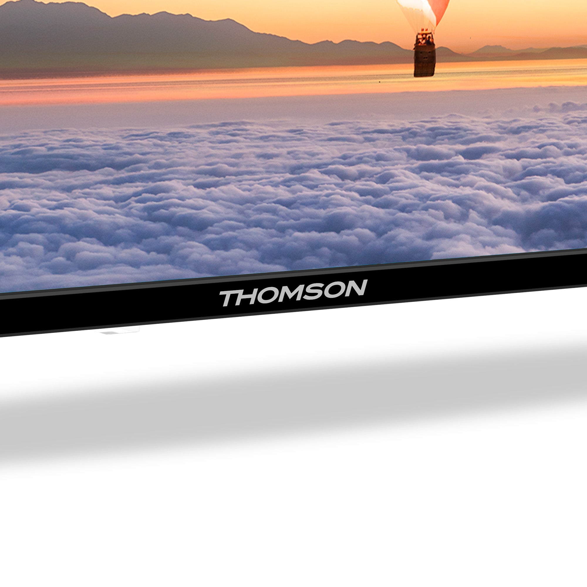Thomson TV displaying a scenic view of a hot air balloon over clouds at sunset.
