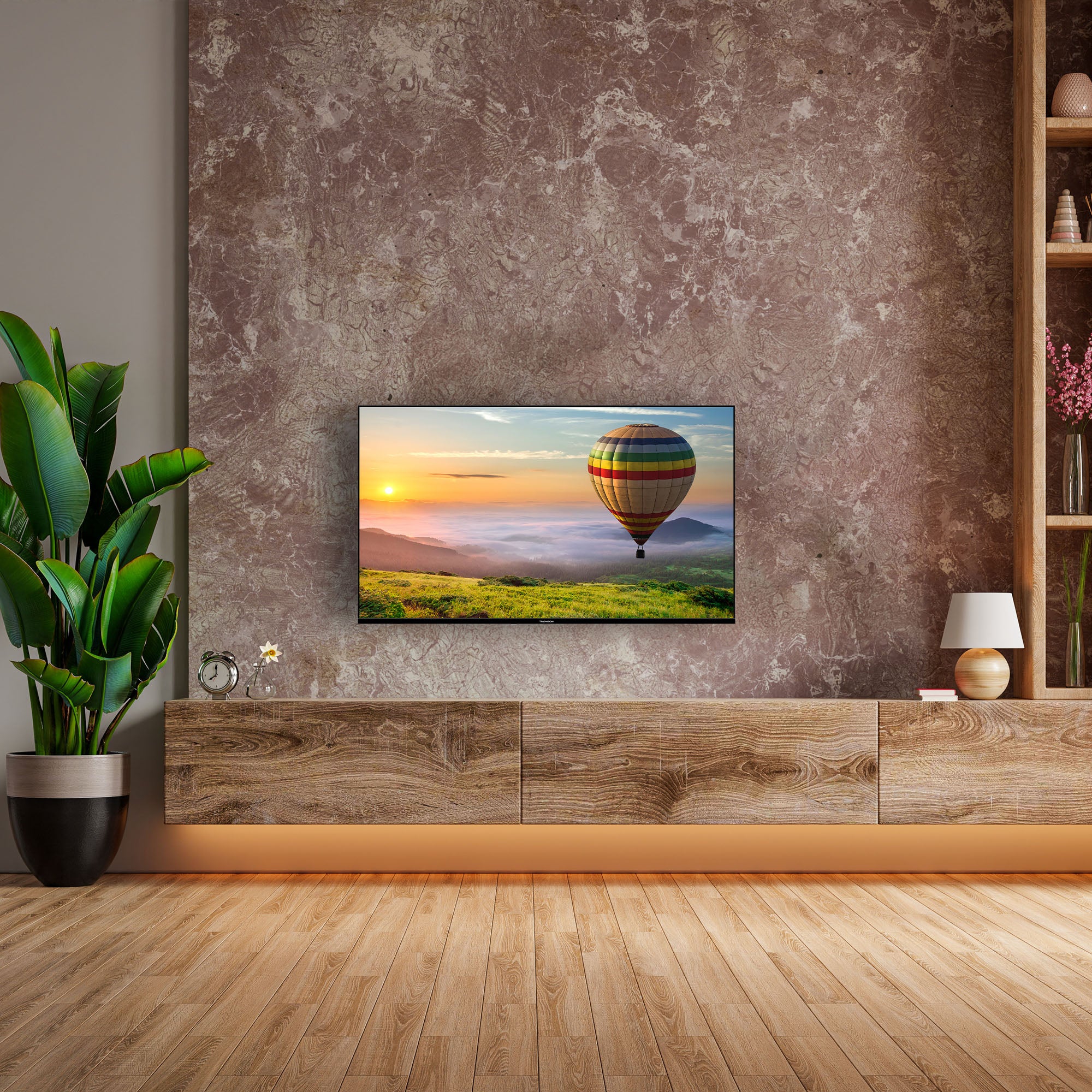 TV mounted on a wall in a modern living room with a colorful balloon scene.