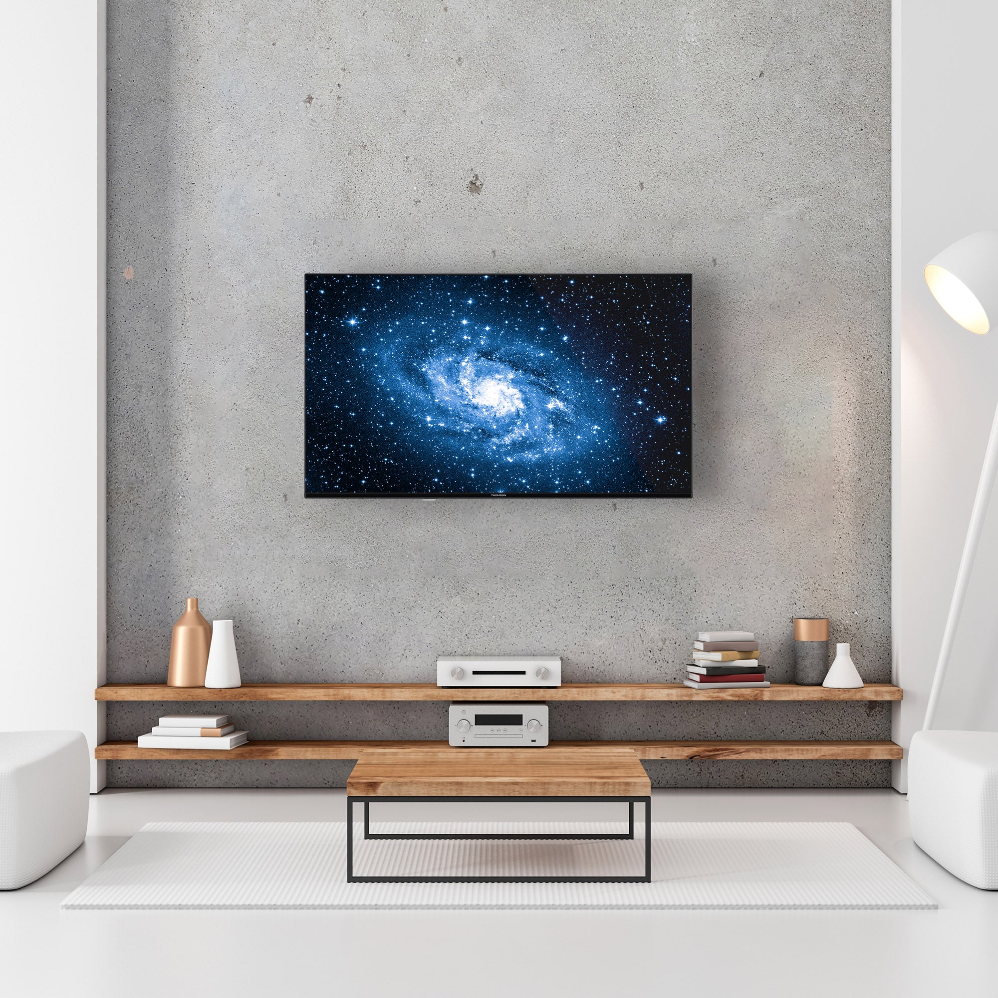 Modern living room with a TV displaying a galaxy image, wooden shelf, and decor items.