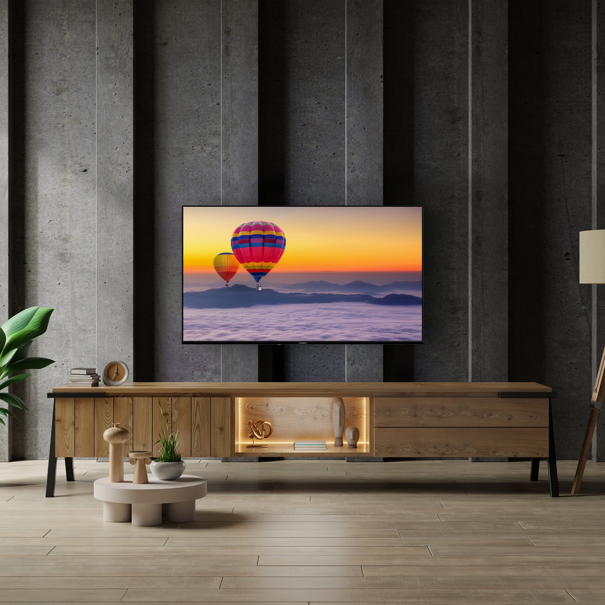 Modern living room with a TV displaying hot air balloons, wooden cabinet, and decorative items.