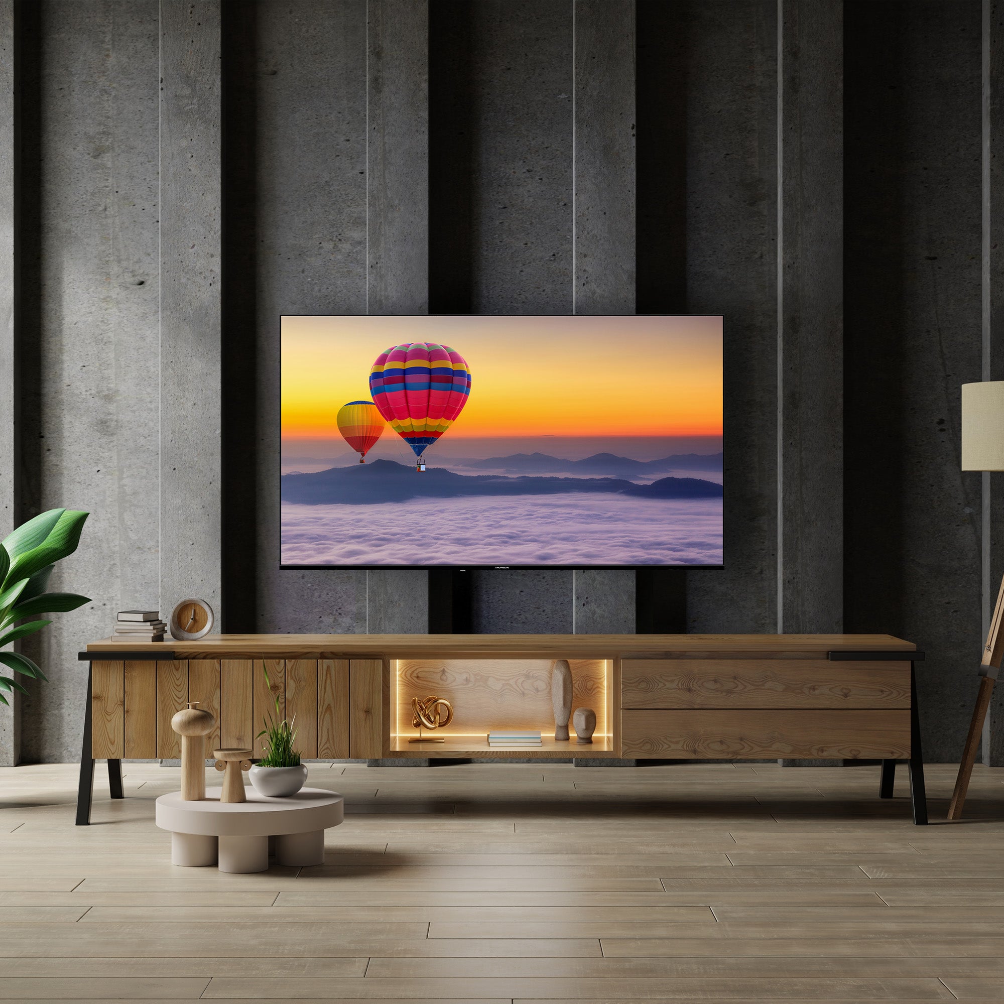 Modern living room with a TV displaying hot air balloons, wooden cabinet, and decorative items.