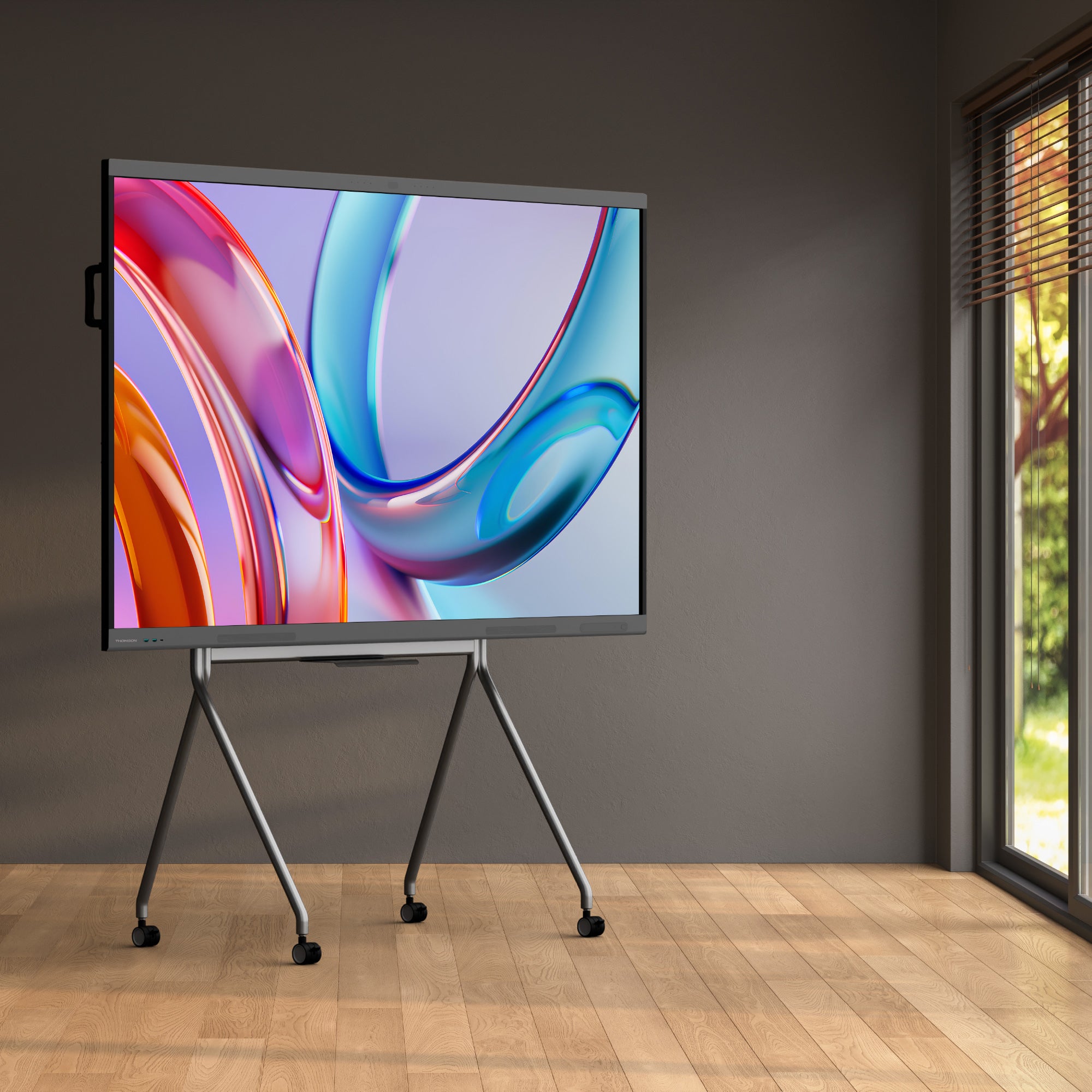 Colorful abstract design on a large screen in a room with a window.