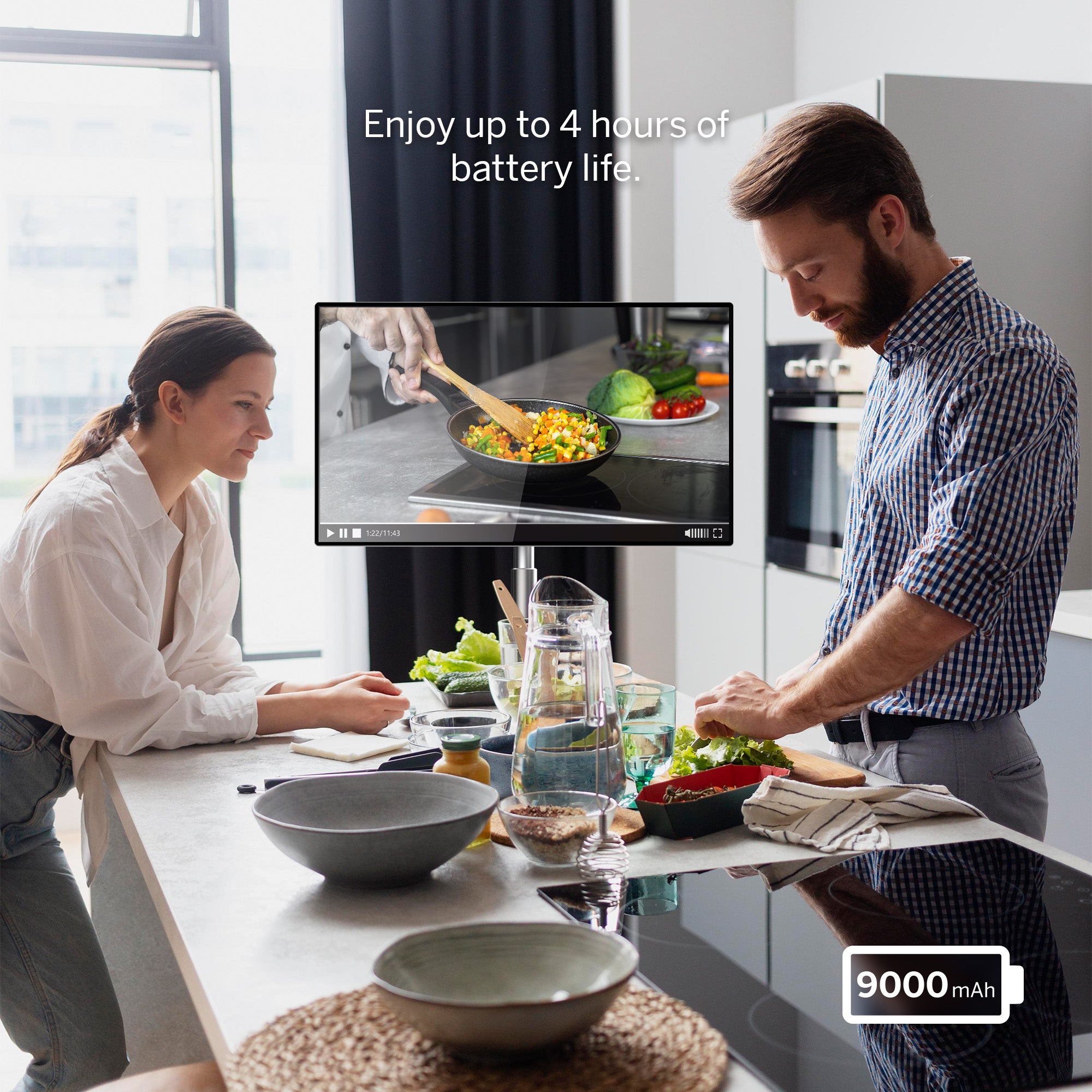 Man and woman in a kitchen with a screen displaying cooking instructions, emphasizing battery life.